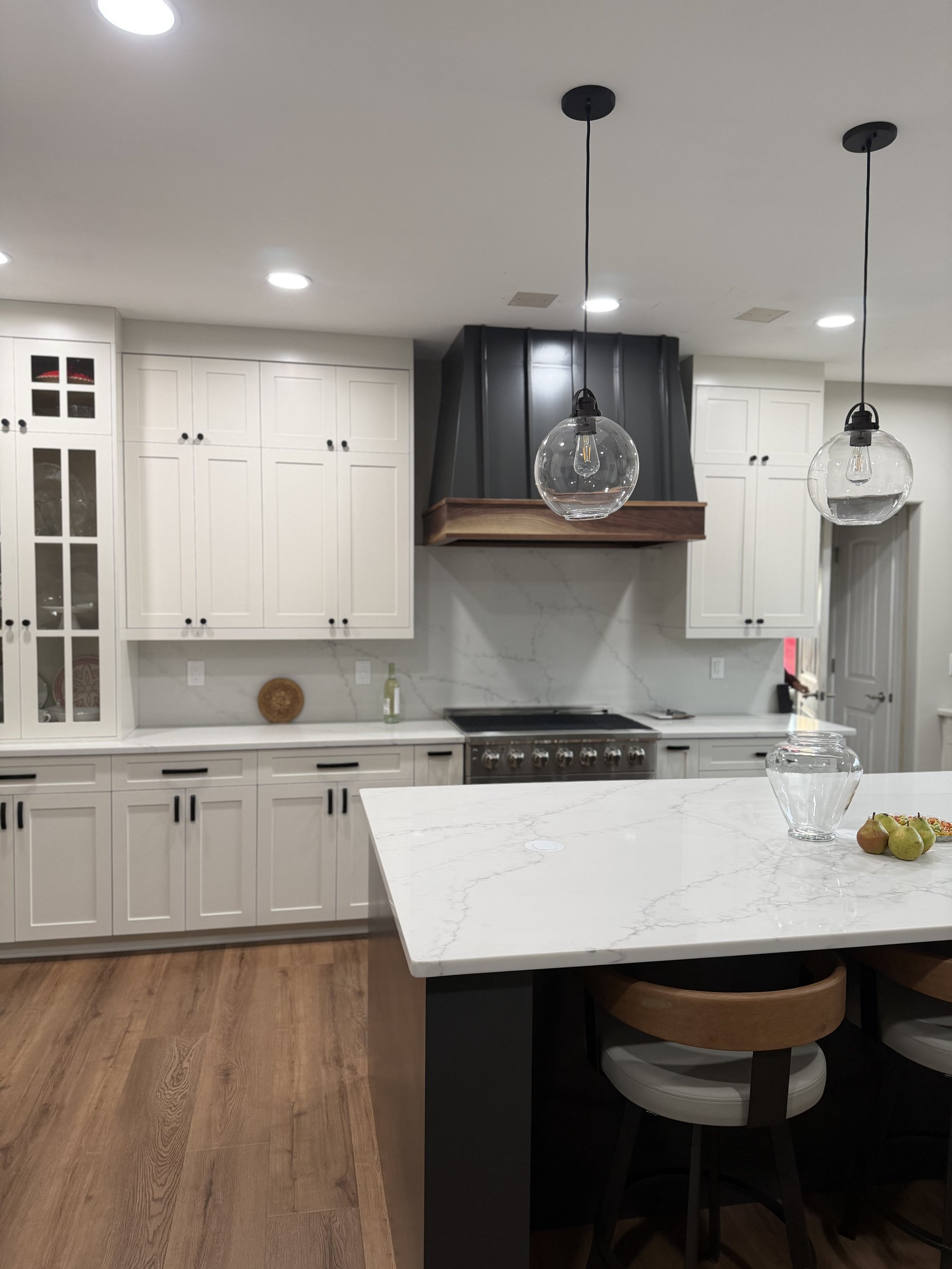 Finished kitchen — white shaker cabinets with quartz island